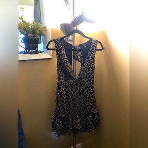 Very cute summer dress, low cut in front and open back.